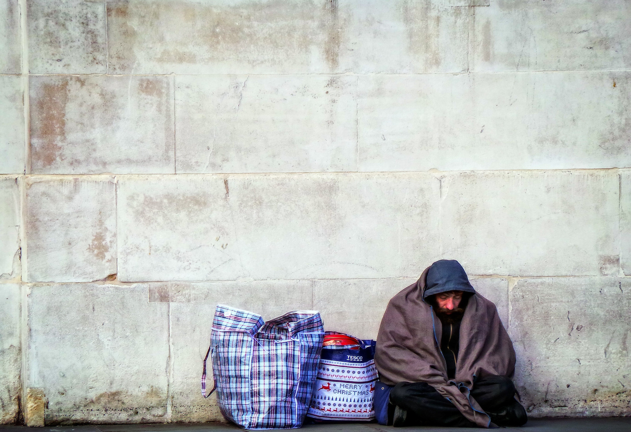 Homeless by a wall