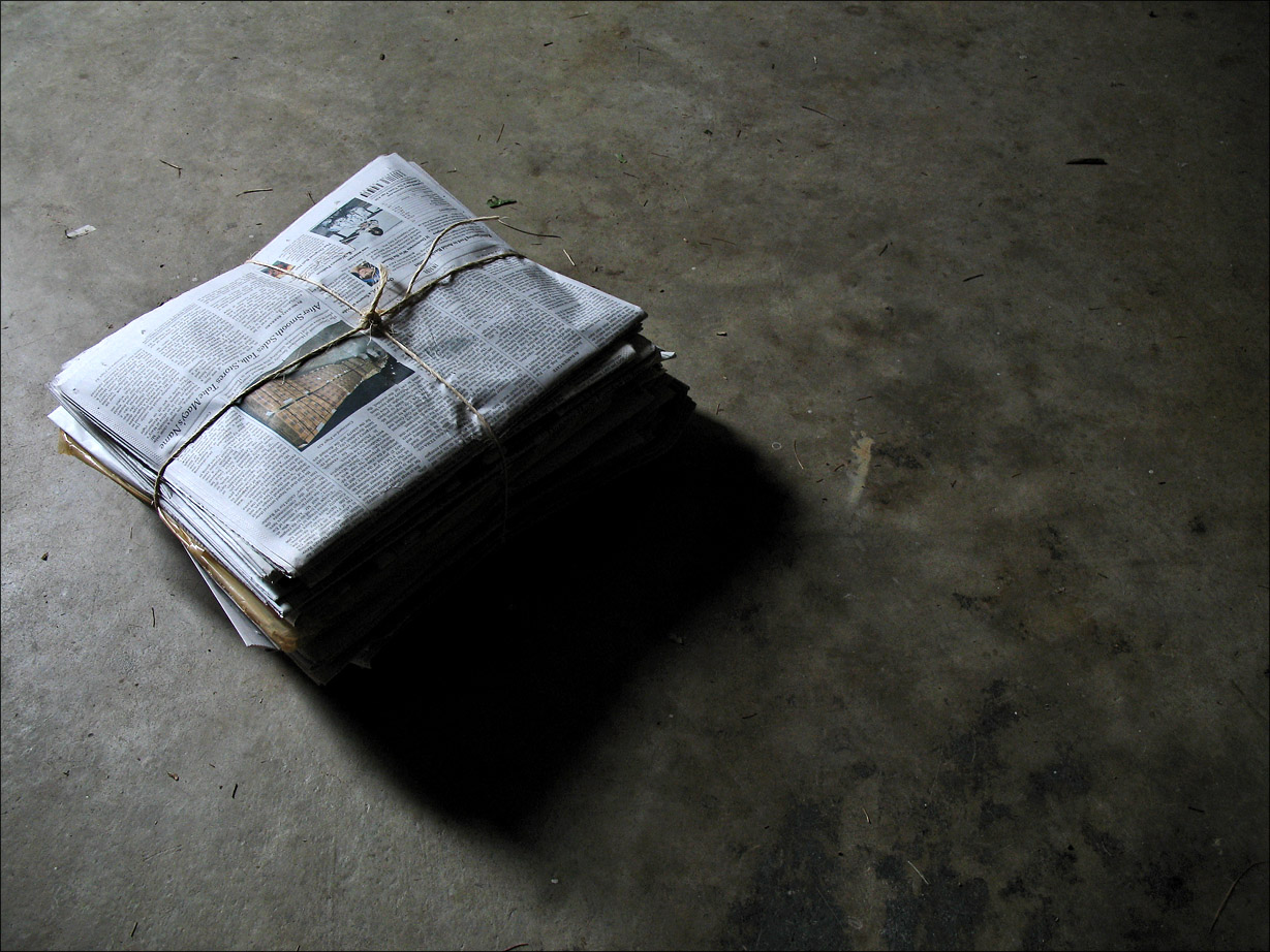 Newspaper stack on floor